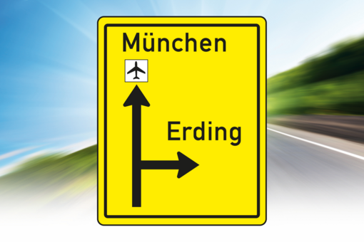 Yellow sign with directional arrows.