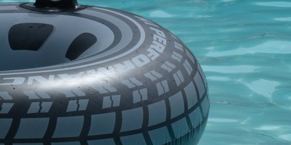 Car tire as swimming ring in pool