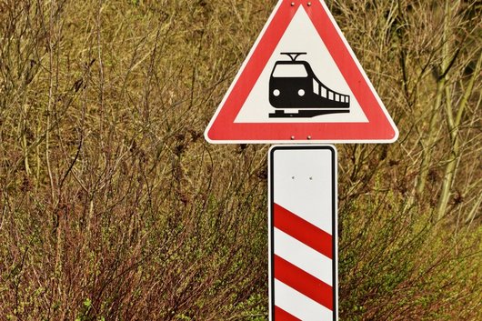 Traffic sign warns of level crossing.