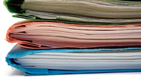 Stack of documents in three folders