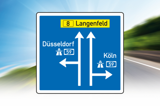 Blue signpost shows way to motorway and main road.