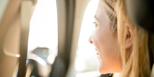 Junge Frau lächelnd im Auto